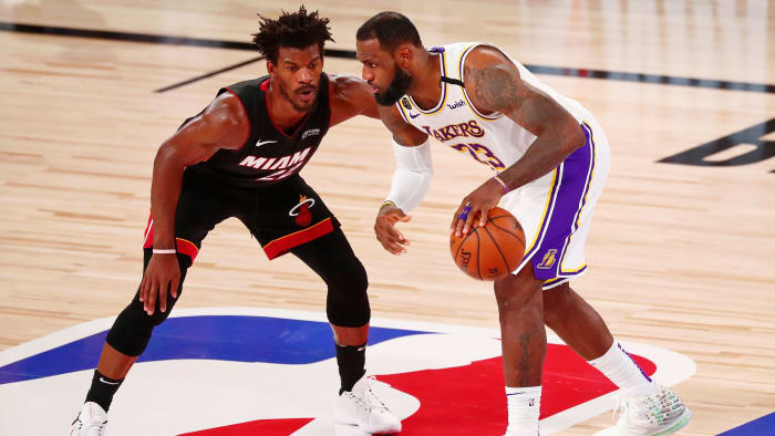 Lakers forward LeBron James dribbles while defended by Heat forward Jimmy Butler during the 2020 NBA Finals.